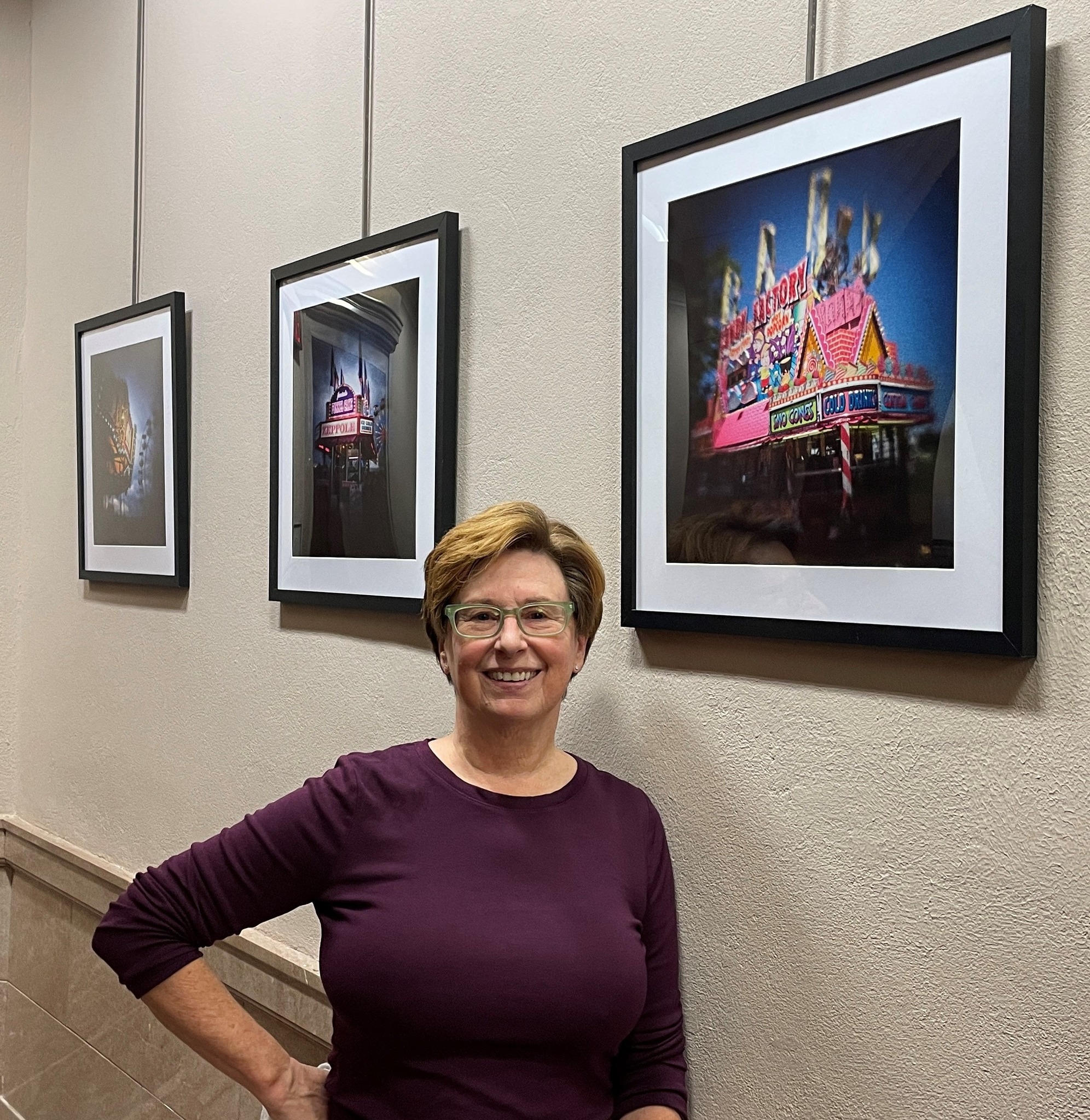 Artist standing in front of work in the gallery